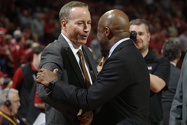 Texas A&M coach Billy Kennedy, left, and Arkansas coach Mike Anderson shake hands prior to a game Wednesday, Feb. 22, 2017, in Fayetteville. 