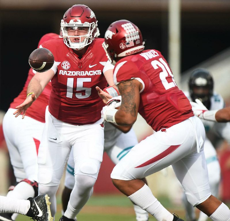 NWA Democrat-Gazette/J.T. WAMPLER Arkansas quarterback Cole Kelley pitches the ball to Devwah Whaley Saturday Nov. 4, 2017 against Coastal Carolina. Arkansas won 39-38.