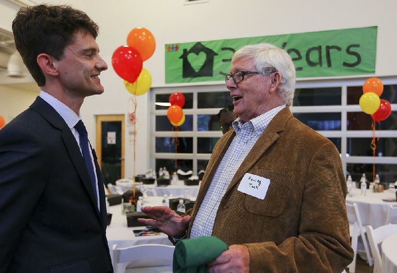 Our House Executive Director Ben Goodwin (left) and Our House founding board President Henry Tuck discuss the growth of the organization over its 30 years during a lunch Tuesday at the organization’s anniversary celebration. 
