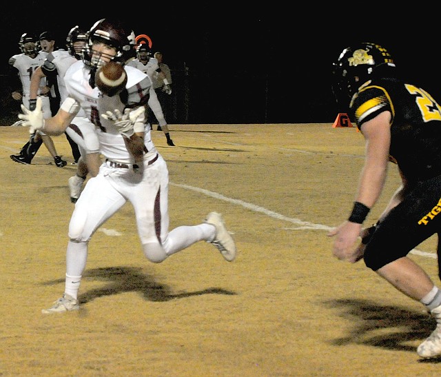 MARK HUMPHREY ENTERPRISE-LEADER Lincoln sophomore Cordelle Whetsell intercepts a pass intended for Prairie Grove wingback Dustin Burton (right). Whetsell returned the pick 85 yards for a touchdown, but the Tigers overwhelmed Lincoln, 56-25, Friday to claim a share of the 4A-1 Conference title thanks to Shiloh Christian's 17-14 upset of Pea Ridge.