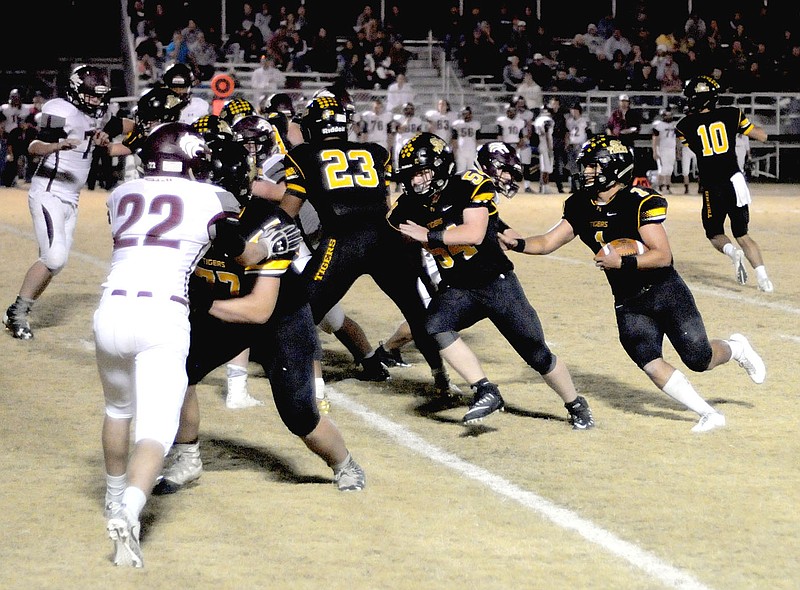 MARK HUMPHREY ENTERPRISE-LEADER Prairie Grove senior Anthony Johnson follows his blockers at the point of attack. Johnson ran 25 yards for a touchdown on this play. Prairie Grove beat Lincoln, 56-25, Friday.