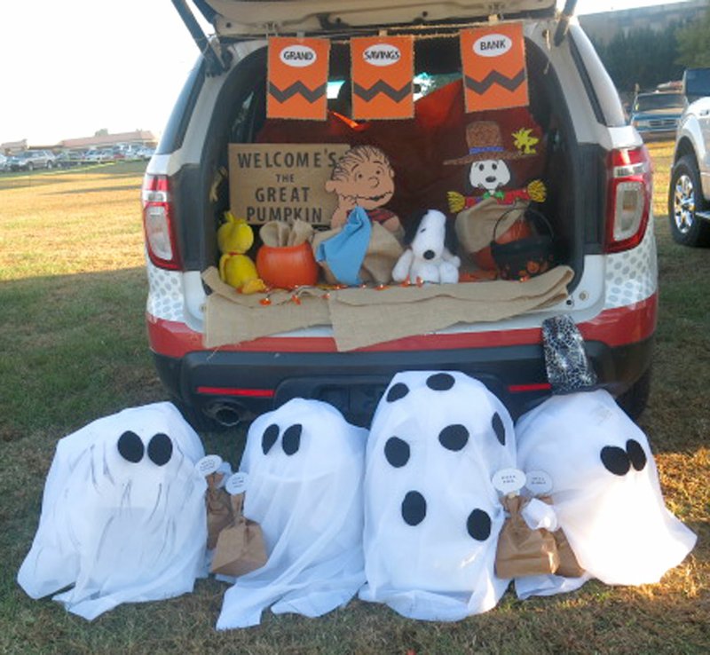 Representatives of Grand Savings Bank joined Charlie Brown, Snoopy and a host of ghostly trick or treaters in welcoming the Great Pumpkin at their trunk at the OCH fall festival Saturday evening, Oct. 28. Bank employees said GSB is expecting to open its new branch in Gravette in about a month.