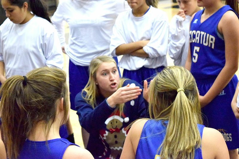 Photo by Mike Eckels Ashley Riggles discussed a change in the team's game plan during a junior-high basketball game at Peterson Gym in Decatur Dec. 15, 2016. Riggles will take over as the Lady Bulldogs head coach's position this season from Jeff Melton, who will be the assistant boys' basketball coach this season.