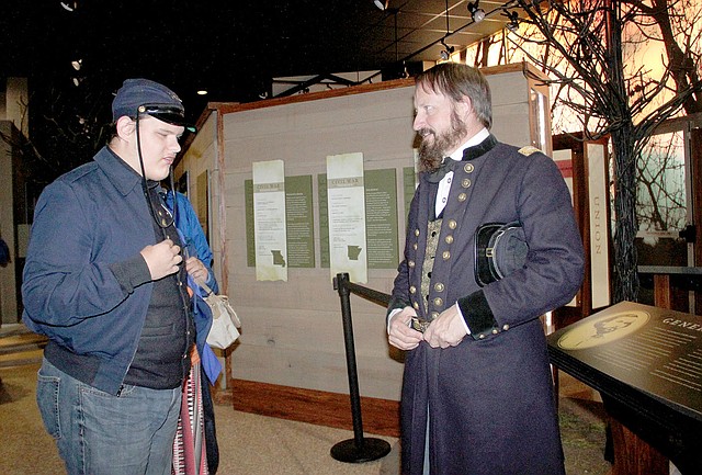 LYNN KUTTER ENTERPRISE-LEADER Jim Spillars, portraying General James Blunt, talks to Coby Turney of Lincoln about the Battle of Prairie Grove. Coby was attending the state park's first Night at the Museum.
