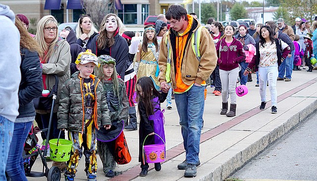 Photo by Randy Moll Sidewalks along Gentry's Main Street were lined with children and their parents and grandparents during the trick-or-treat event sponsored by the Gentry Chamber of Commerce on Oct. 31.