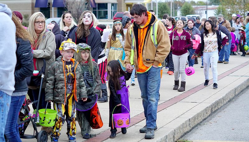 Photo by Randy Moll Sidewalks along Gentry's Main Street were lined with children and their parents and grandparents during the trick-or-treat event sponsored by the Gentry Chamber of Commerce on Oct. 31.