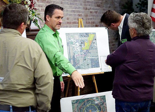 Photo by Randy Moll Gentry's mayor, Kevin Johnston (center), talks to council members Jason Barrett and Janice Arnold about park locations in the city of Gentry and possible uses of those locations for amenities such as baseball diamonds, soccer fields and more at an information gathering meeting in the McKee Community Room at the Gentry Public Library on Oct. 30. Nathan Street of McClelland Consulting Engineers, of Fayetteville, was looking at a map of future park land which was on display.