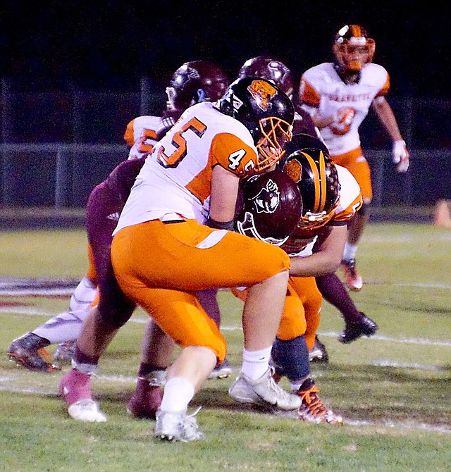 Photo by Randy Moll Gravette's Kenton Tajchman and Bailey Soule' stopped a run by Gentry's Myles McFerron during play between the two rivals at Gentry High School on Friday, Nov. 3, 2017.