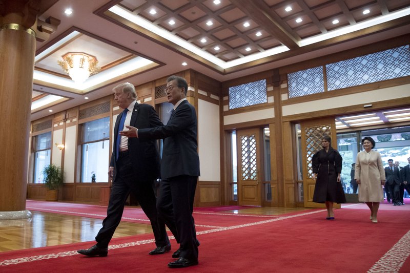 The Associated Press PRESIDENTS ARRIVE: U.S. President Donald Trump and South Korean President Moon Jae-in arrive for a guest book signing ceremony at the Blue House in Seoul, South Korea on Tuesday. Trump is on a five-country trip through Asia traveling to Japan, South Korea, China, Vietnam and the Philippines. Also pictured are first ladies Melania Trump, and Kim Jung-sook, right.