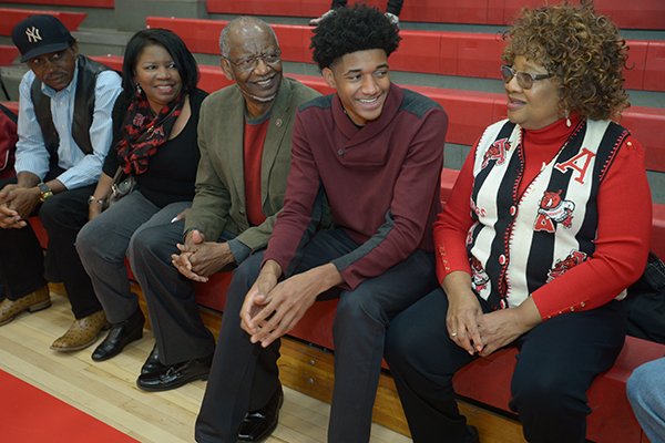 Fort Smith Northside guard Isaiah Joe (center) shares a laugh Wednesday, Nov. 8, 2017, with his grandmother, Emma Watts (from right); grandfather, Lonnie Watts; grandmother Ferry Simmons; and grandfather, Douglas Simmons; before signing to play basketball with Arkansas during a signing ceremony at the school.
