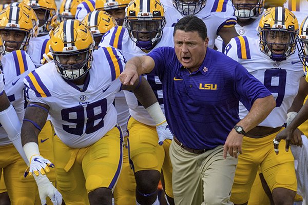 LSU head coach Ed Orgeron leads his team onto the field before an NCAA college football game against Auburn in Baton Rouge, La., Saturday, Oct. 14, 2017. (AP Photo/Matthew Hinton)

