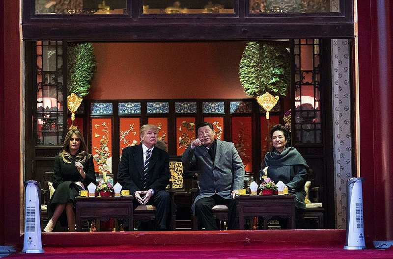 President Donald Trump and Chinese President Xi Jinping watch a performance of a traditional Chinese opera Wednesday in the Forbidden City in Beijing. Their wives joined them for the performance. 