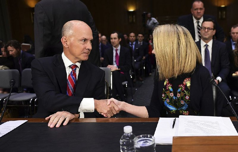 Richard Smith, former chief executive of Equifax, greets Marissa Mayer, former CEO of Yahoo, as they prepare to testify Wednesday before a Senate Commerce Committee hearing on data breaches.  