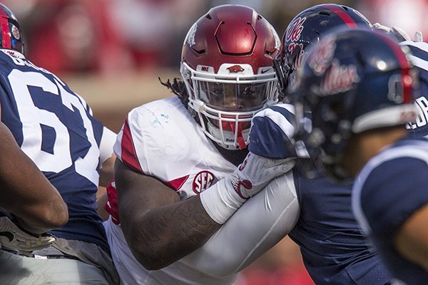 Arkansas defensive end McTelvin Agim is blocked during a game against Ole Miss on Saturday, Oct. 28, 2017, in Oxford, Miss. 