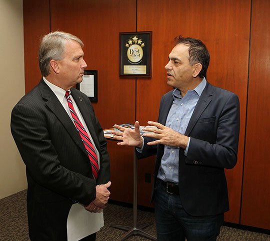 The Sentinel-Record/Richard Rasmussen TAX CREDIT SUPPORTERS: Gary Troutman, left, president and CEO of The Greater Hot Springs Chamber of Commerce, talks with Arlington Resort Hotel & Spa owner Al Rajabi Wednesday prior to a news conference in support of the Federal Historic Rehabilitation Tax Credit which Congress may eliminate in a new tax reform bill.