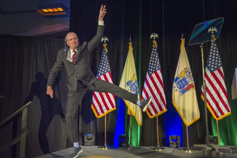 The Associated Press HAPPY DAY: New Jersey Gov.-elect Phil Murphy leaps as he jumps onto the stage at his victory party Tuesday in Asbury Park, N.J.