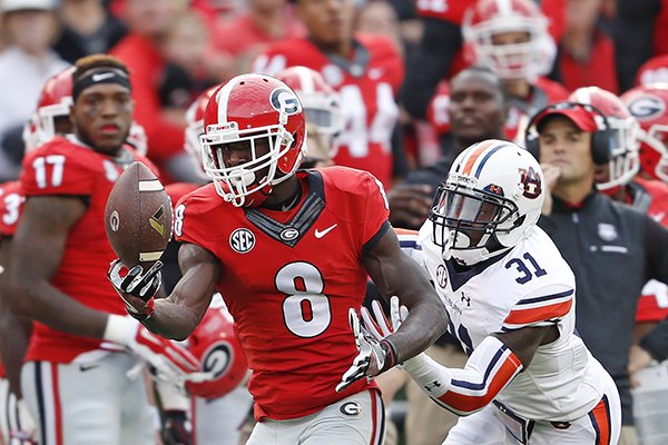 Georgia wide receiver Riley Ridley (8) makes a catch as Auburn defensive back Javaris Davis (31) defends in the first half of an NCAA college football game Saturday, Nov. 12, 2016, in Athens, Ga. (AP Photo/John Bazemore)
