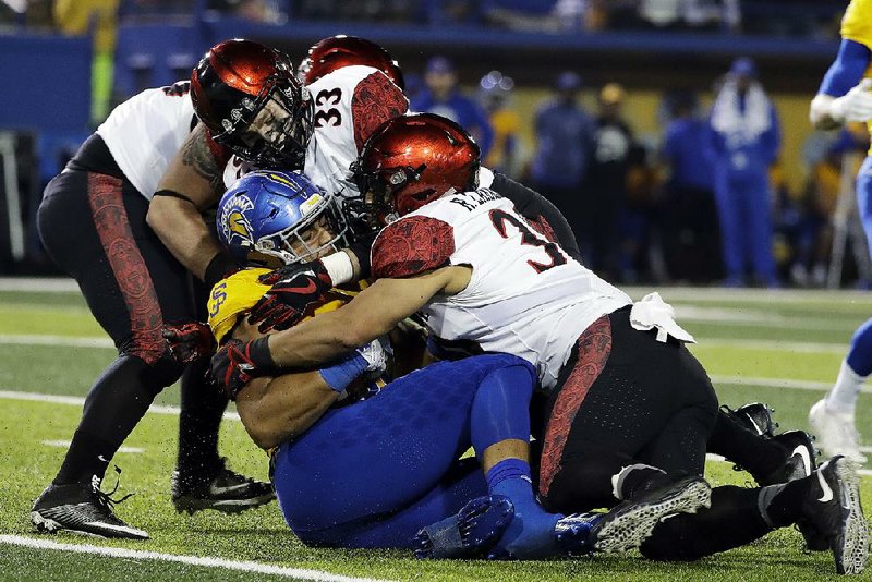 San Diego State safety Parker Baldwin (top) of Siloam Springs had 7 tackles, including 4 solo tackles, and 1 interception to lead the Aztecs to a 52-7 victory over San Jose State on Saturday.