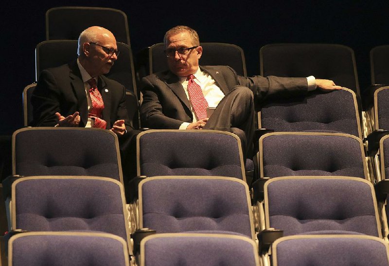 University of Arkansas Chancellor Joe Steinmetz (left) talks with Athletic Director Jeff Long before a UA board of trustees meeting Thursday morning in North Little Rock.