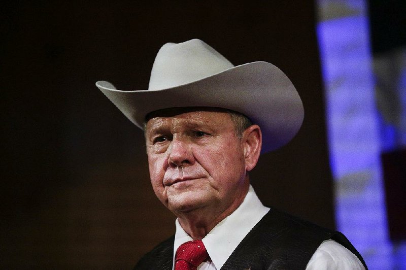 In this Monday, Sept. 25, 2017, file photo, former Alabama Chief Justice and U.S. Senate candidate Roy Moore speaks at a rally, in Fairhope, Ala. According to a Washington Post story Nov. 9, an Alabama woman said Moore made inappropriate advances and had sexual contact with her when she was 14.