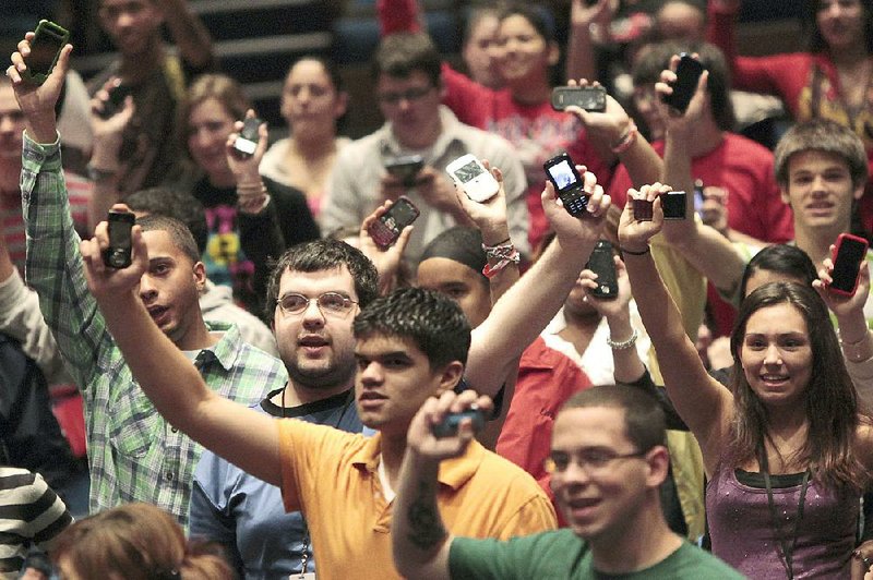 Seniors from the newly renamed Savannah Janine Shields High School in Fatyetteville raise their cellphones when asked how many never leave home without them.Fayetteville-born Otus the Head Cat’s award-winning column of humorous fabrication appears every Saturday.
