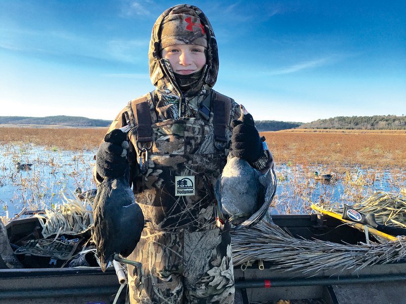 Eleven-year-old Tanner Holden of Benton holds a brace of coots that will eventually grace his family’s dinner table.