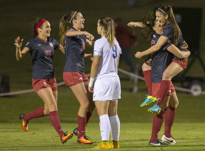 Arkansas' Jessi Hartzler (from left), Kayla McKeon, Lindsey Mayo and Cailee Dennis celebrate as Memphis' Valerie Sanderson (near) watches on Friday, Nov. 11, 2016, after Mayo's game-winning goal in their NCAA tournament first round game at Razorback Field in Fayetteville.