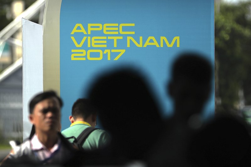 Visitors wait to go through a security check at the media center for Asia-Pacific Economic Cooperation (APEC) leaders summit in Danang, Vietnam, Thursday, Nov. 9, 2017. (AP Photo/Mark Schiefelbein)