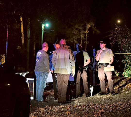The Sentinel-Record/Mara Kuhn JUVENILE SHOT: Garland County sheriff's investigators work the scene of a reported shooting at 104 Fernwood St. Thursday evening. The victim, a male juvenile, was initially transported to a field at Lakeside School to be airlifted to a hospital, but was instead transported by ambulance to an area hospital where his condition was unknown at presstime. 