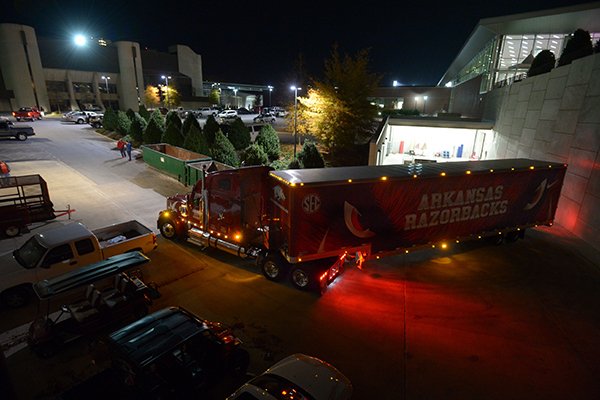 A semi-truck and trailer prepares to leave the Fred Smith Football Center Thursday, Nov. 9, 2017, before heading out to Baton Rouge, La., ahead of the Razorbacks' game with LSU Saturday. Jerry Rico of Fayetteville and Rodney Collins of Pensacola, Fla., are employees of J.B. Hunt Transport and the work together to drive equipment necessary for the Razorbacks football team to and from games away from Fayetteville.