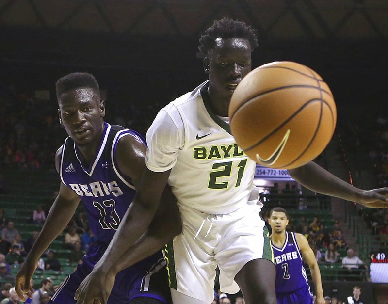 Baylor forward Nuni Omot and Central Arkansas forward Otas Iyekekpolor watch as the loose ball goes out of bounds in the second half Friday, Nov. 10, 2017, in Waco, Texas.