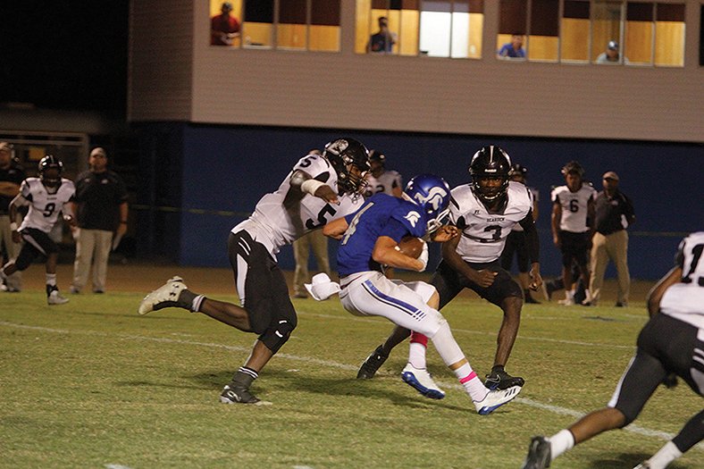 Terrance Armstard/News-Times Parkers Chapel's Canon Morgan (4) tries to elude Bearden's Robert Miller (5) and Tyler Berry (3) during their 8-2A contest earlier this season. Tonight, the Trojans open the 2A playoffs by traveling to Hazen for a clash with the 6-2A champions. Game time is set for 7 p.m.