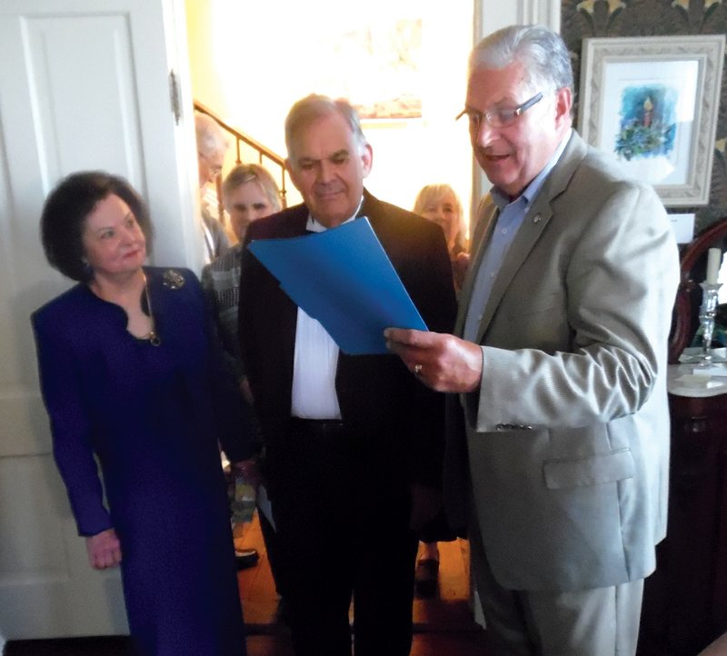 Searcy artist Howard Johnson, center, and his wife, Sandra Joyner Johnson, listen as Searcy Mayor David Morris, right, proclaims Nov. 4 as Howard Johnson Day and presents the painter with a key to the city during a reception at Black House.