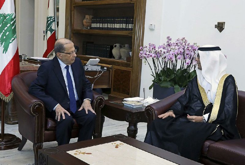 Lebanese President Michel Aoun (left) meets Friday with Walid al-Bukhari, Saudi charge d’affaires in Lebanon, at the Presidential Palace near Beirut. Aoun called for the Saudis to release Lebanese Prime Minister Saad Hariri, saying the way he resigned “was unacceptable.” 