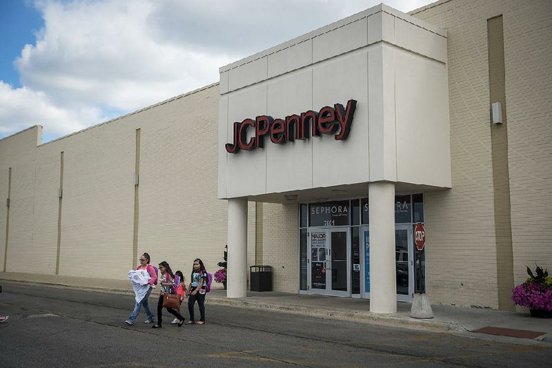 Shoppers leave a J.C. Penney store in Chicago earlier this year. The company reported a quarterly loss of $128 million, or 41 cents a share, compared with a loss of $67 million, or 22 cents a share, a year ago. 