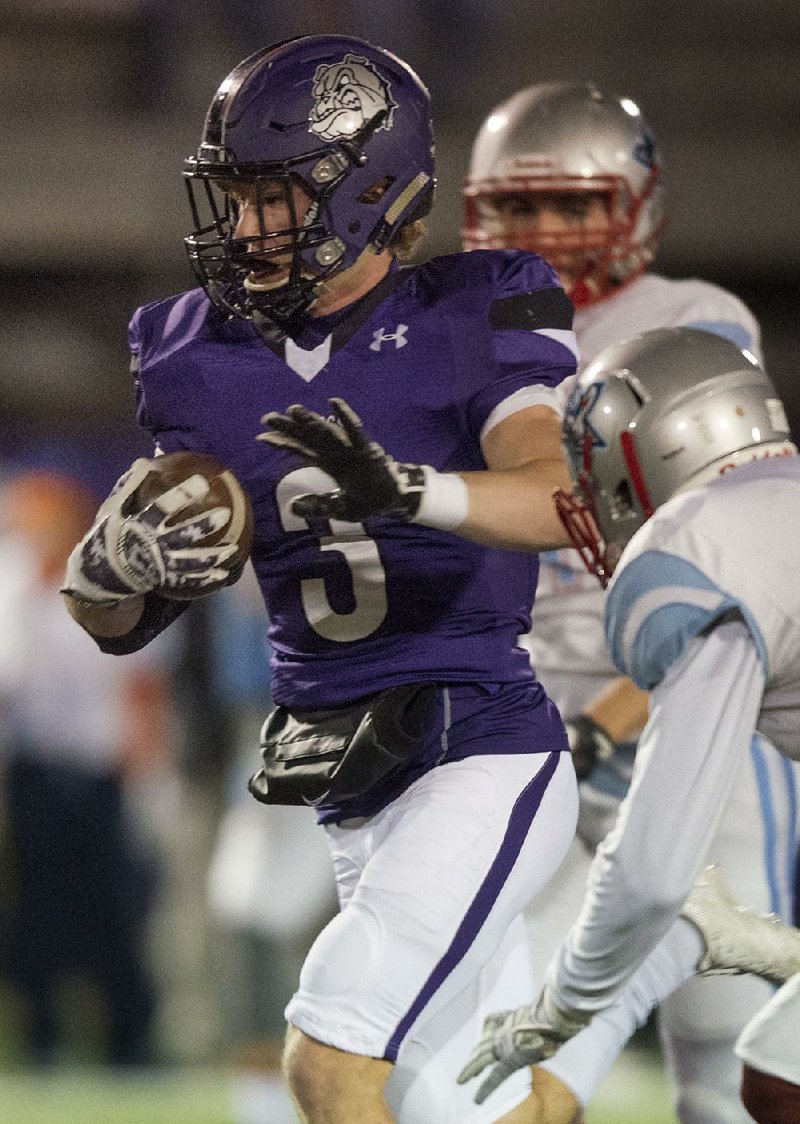 Fayetteville running back Nate Nolen (3) looks to avoid a Fort Smith Southside defender Friday during the Bulldogs’ 64-34 victory over the Mavericks in the Class 7A state playoffs in Fayetteville. Nolen rushed for 150 yards and 1 touchdown on 14 carries.
