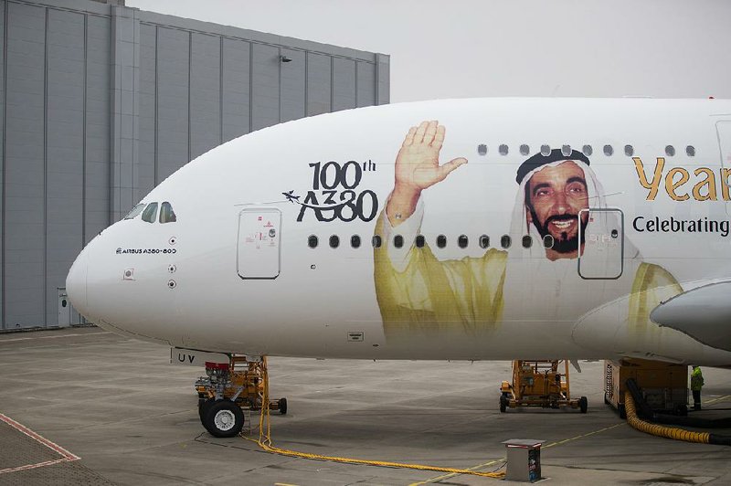 A portrait of Sheikh Ahmed bin Saeed Al Maktoum, chief executive officer of Emirates Airlines, adorns an Airbus SE A380 aircraft as Emirates take delivery of their 100th A380 passenger jet in Hamburg, Germany, in early November.