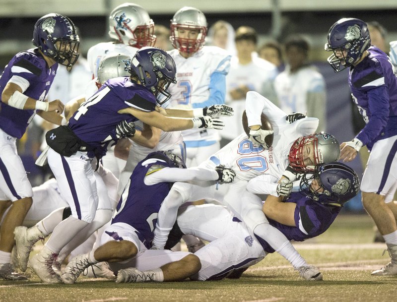 NWA Democrat-Gazette/CHARLIE KAIJO Fayetteville defenders bring down Fort Smith Southside receiver Mason Love (80) during Friday's playoff game at Harmon Field in Fayetteville.