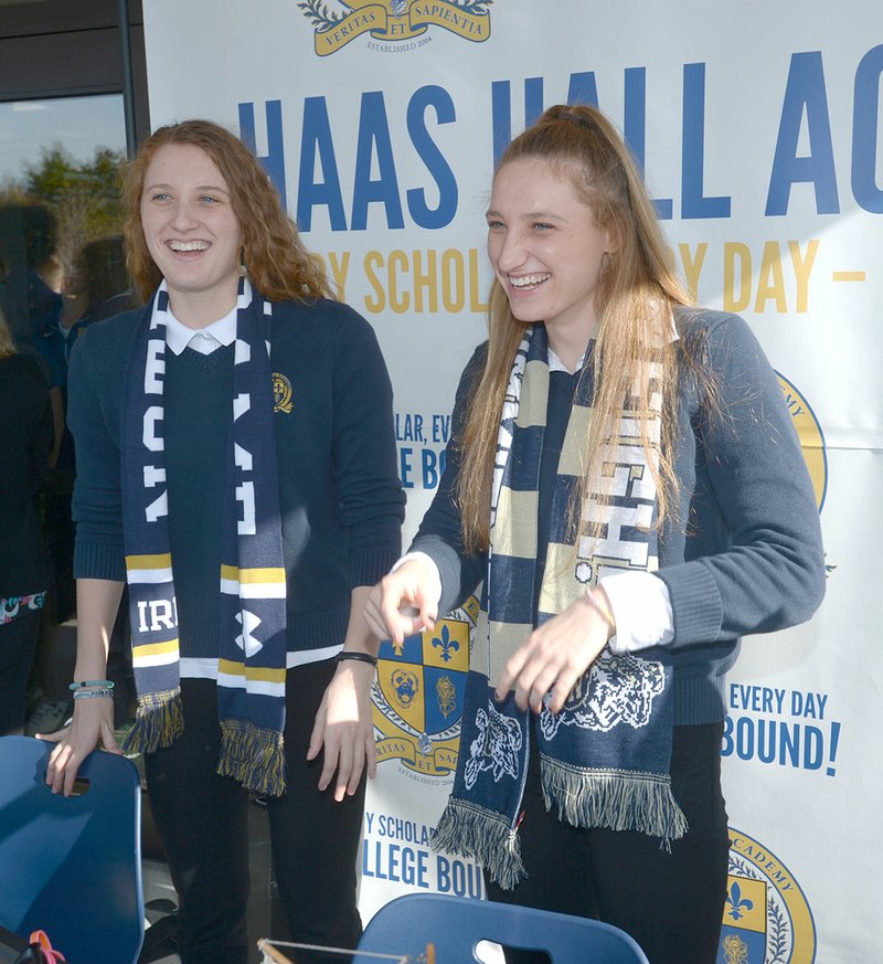 NWA Democrat-Gazette/ANDY SHUPE Haas Hall swimmers Luciana Thomas (left) and her twin sister, Martina Thomas, laugh with friends Friday before signing letters of intent to swim in college at their school in Fayetteville. Luciana signed with Notre Dame and Martina with the Naval Academy.