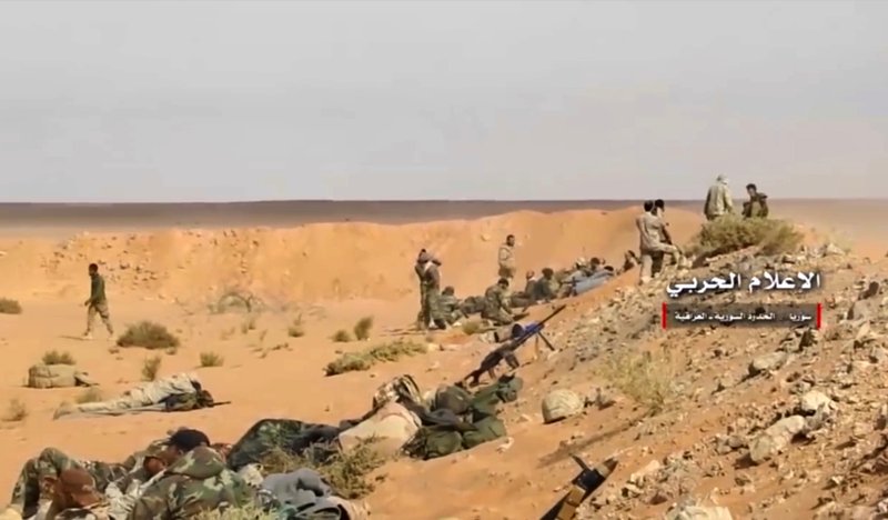 This frame grab from video provided Wednesday, Nov 8, 2017 by the government-controlled Syrian Central Military Media, shows pro-government troops taking up positions on the Iraq-Syria border. 