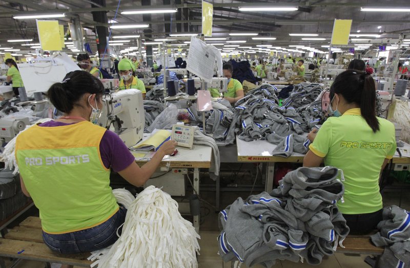 In this Oct. 24, 2017, photo, garment workers sew clothes at Pro Sports factory in Nam Dinh province, Vietnam. U.S. President Donald Trump's decision to withdraw from a far-reaching Pacific Rim trade pact is having scant impact on fast-growing trade in the region. 