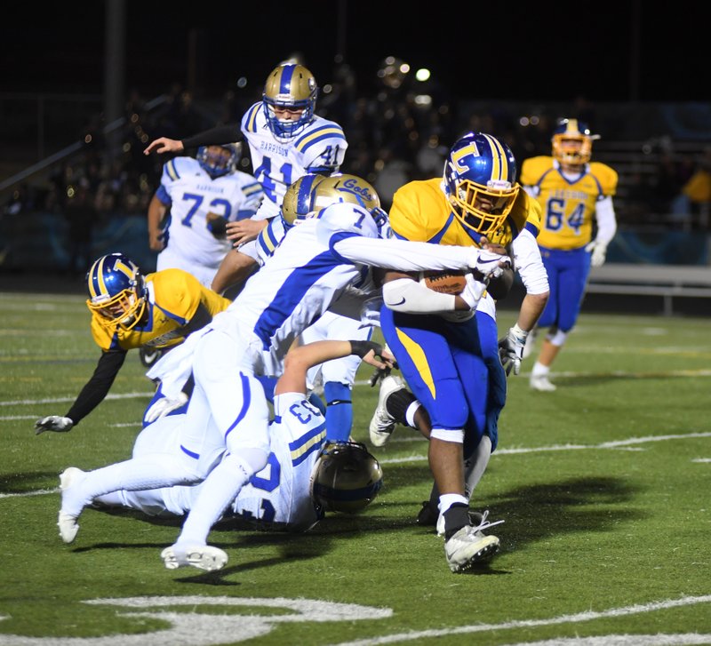 The Sentinel-Record/Mara Kuhn MOVING DOWNFIELD: Lakeside's Dupree Swanson (35) runs the ball as Harrison's Tyler Hutcheson (7) defends during Friday night's first round 5A state playoff game at Austin Field.