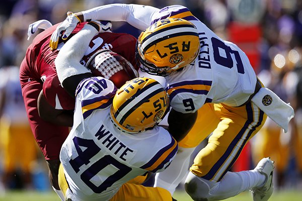 Arkansas running back Devwah Whaley (21)is tackled by LSU linebacker Devin White (40) and safety Grant Delpit (9) in the first half of an NCAA college football game in Baton Rouge, La., Saturday, Nov. 11, 2017. (AP Photo/Gerald Herbert)

