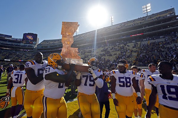 LSU players carry The Boot trophy after an NCAA college football game against Arkansas in Baton Rouge, La., Saturday, Nov. 11, 2017. LSU won 33-10. (AP Photo/Gerald Herbert)

