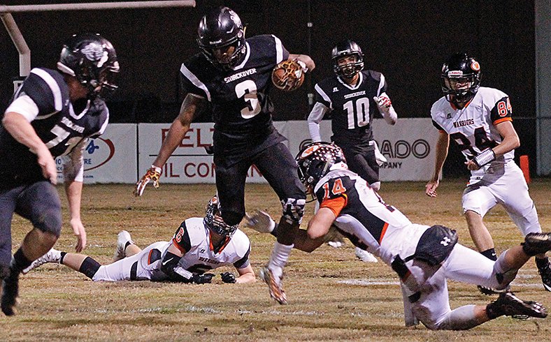 Kate Fields/News-Times Smackover's Jaqueze Modica (3) tries to leap past Lamar's Joe Mueller (14) during their clash in the opening round of the 3A playoffs in Smackover on Friday night. The Bucks advanced with a 49-28 win, and will play at Mayflower next week.