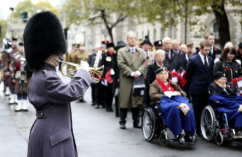 People at the Cenotaph war memorial in London take part in the Western Front Association’s annual service of remembrance Saturday, one of numerous events across Europe marking the anniversary of the end of World War I. 
