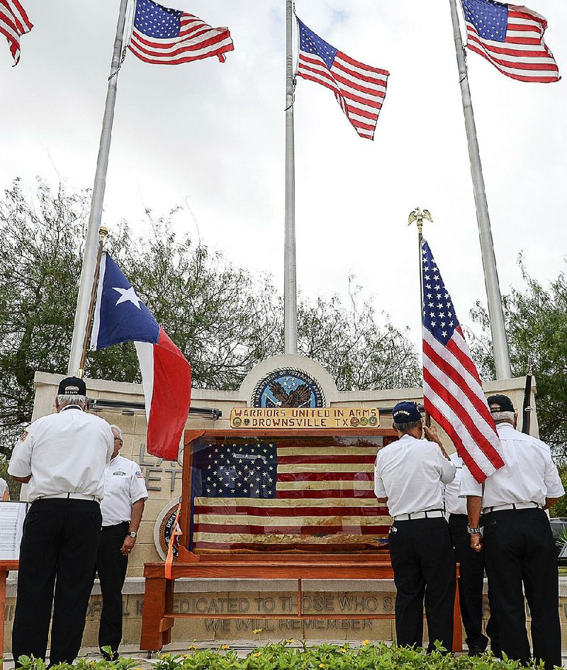 An honor guard presents the colors during a Veterans Day ceremony Saturday in Laguna Vista, Texas.  