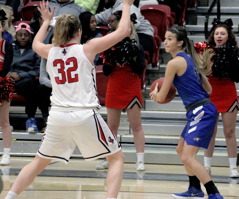 Photo courtesy of Benedictine College John Brown senior Kimmy Deines looks for a pass as Benedictine's Kristen Murphy defends during this past Tuesday's game. Benedictine defeated John Brown 70-67 for the Golden Eagles' first loss of the season. JBU was scheduled to return to action on Saturday against Evangel (Mo.). Results were not available at presstime. The Golden Eagles are back in action this Tuesday at home at 6 p.m. against fellow Arkansas school Crowley's Ridge College.