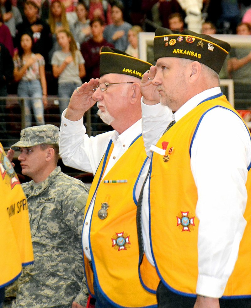 Janelle Jessen/Siloam Sunday Veterans saluted the flag during the annual Veterans Day Program at Siloam Springs High School on Friday. The program was hosted by Veterans of Foreign Wars Post 1674. The National Guard posted the colors and the Siloam Springs High School Choir sang the National Anthem. The high school band also provided music and State Rep. Robin Lundstrum (R-District 87) was the featured speaker. A Veterans Day Parade was held on Saturday morning after press time. For photos of the parade see Wednesday's issue of the Herald-Leader.