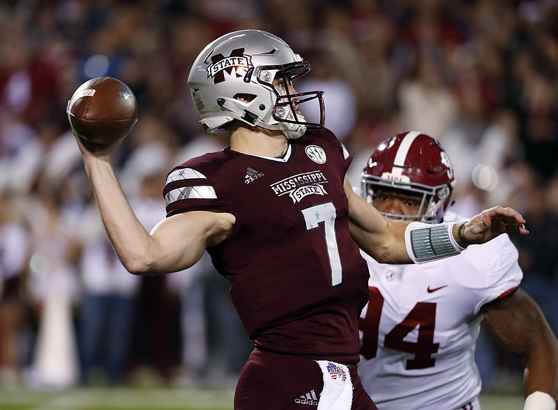 Mississippi State quarterback Nick Fitzgerald (7) throws as Alabama defensive lineman Da'Ron Payne (94) tries to tackle him during the first half of an NCAA college football game in Starkville, Miss., Saturday, Nov. 11, 2017. (AP Photo/Rogelio V. Solis)